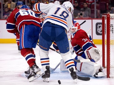 Edmonton Oilers' Zach Hyman (18) fails to control a rebound from Canadiens goaltender Jake Allen in Montreal on Sunday, Feb. 12, 2023.