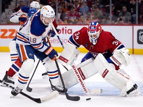 Edmonton Oilers' Zach Hyman (18) takes a shot on Canadiens goaltender Jake Allen in Montreal on Sunday, Feb. 12, 2023.