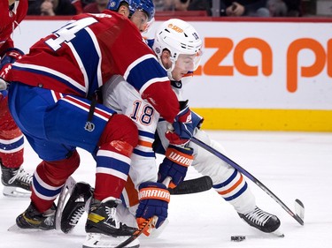 Canadiens defenceman Jordan Harris (54) drags down Edmonton Oilers' Zach Hyman (18) in Montreal on Sunday, Feb. 12, 2023. A penalty was called on the play.