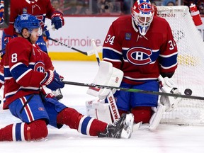 Canadiens defenceman Mike Matheson (8) grimaces as he deflects a shot with his leg as Canadiens goaltender Jake Allen looks on against the Edmonton Oilers at the Bell Centre on Sunday, Feb. 12, 2023.