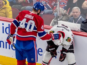 Montreal Canadiens right wing Joel Armia (40) checks Chicago Blackhawks defenceman Jack Johnson (8) after accidentally high sticking him during 2nd period NHL action at the Bell Centre in Montreal on Tuesday Feb. 14, 2023.