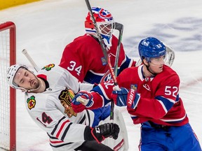 Chicago Blackhawks left wing Boris Katchouk (14) avoids the stick of Montreal Canadiens defenceman Justin Barron (52) in front of Montreal Canadiens goaltender Jake Allen (34) during 2nd period NHL action at the Bell Centre in Montreal on Tuesday Feb. 14, 2023.