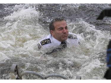 Fady Dagher, directeur du Service de police de la Ville de Montréal (SPVM) briefly wades in the frigid waters of the Lachine Canal on Saturday, Feb. 18, 2023, for the 15th edition of the Polar Bear Challenge.