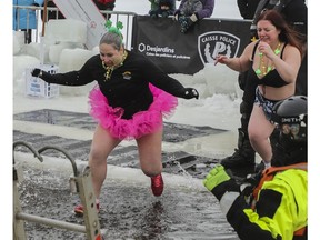 It's not tutu cold: Margaret Marak (left) and other members of the Verdun Ice-Breakers jump into the frigid waters of the Lachine Canal on Saturday, Feb. 18, 2023, for the 15th edition of the Polar Bear Challenge.