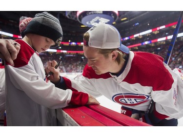 Canadiens goalie Sam Montembeault signs an autograph for Emmerick Blanchet at the Canadiens skills competition at the Bell Centre in Montreal on Sunday, Feb. 19, 2023.