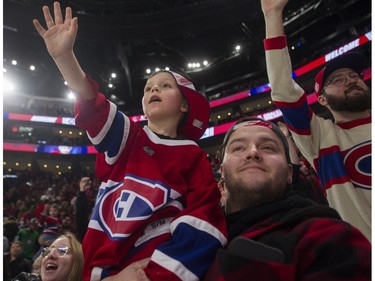Nathann Choinière and his father, Jean-François, watch the Canadiens' skills competition at the Bell Centre in Montreal on Sunday, Feb. 19, 2023.