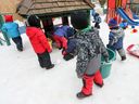 Children play in the snow at a CPE daycare in downtown Montreal.