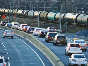 A CN freight train passes next to traffic merging onto Highway 20 at Fenelon Ave. in Dorval, west of Montreal Wednesday November 20, 2013. "The western half of the Island of Montreal is dominated by the busiest rail corridor in Canada," Don Sancton writes.