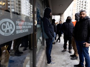 People wait almost three hours in line at the SAAQ outlet on St-Jacques St. in Montreal on Wednesday, February 22, 2023.