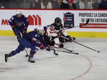 Team Canada's Marie-Philip Poulin pulls away from team USA's Megan Keller, during first period action in the final game of the women's hockey Rivalry Series in Laval on Wednesday Feb. 22, 2023.