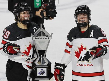 Team Canada captain Marie-Philip Poulin carries Rivalry trophy with teammate Blayre Turnbull following third period action, where Canada defeated team USA 5-0 in the final game of the women's hockey Rivalry Series in Laval on Wednesday Feb. 22, 2023. Canada won the series 4 games to 3.