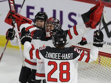 Team Canada goalie Ann-Renée Desbiens celebrates with teammate Micah Zandee-Hart after winning 5-0 against team USA during third period action in the final game of the women's hockey Rivalry Series in Laval on Wednesday Feb. 22, 2023.
