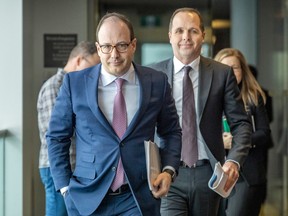 Caisse de dépot CEO Charles Emond is followed by executive vice-president Vincent Delisle as they leave a press conference revealing the Caisse's annual results at their headquarters in Montreal on Thursday, Feb. 23, 2023.
