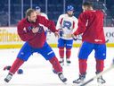 Forward Brandon Gignac, left, play fights with a team-mate after Laval Rocket practice at the Place Bell Sports Complex in Laval on Feb. 28, 2023.
