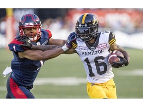 Montreal Alouettes' Ciante Evans pushes Hamilton Tiger-Cats Brandon Banks out of bounds during game in Montreal on July 4, 2019.
