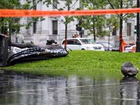 The statue of Sir John A. Macdonald lies in two pieces at the base of the monument from which it was pulled during a demonstration by the Coalition for BIPOC Liberation in Montreal Saturday August 29, 2020.