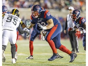 Montreal Alouettes offensive-lineman Nick Callender comes off the line of scrimmage to block Hamilton Tiger-Cats' Julian Howsare during second half in Montreal on Sept. 23, 2022.