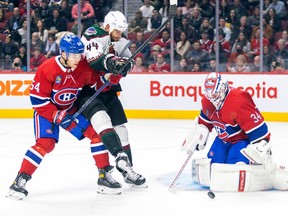 Montreal Canadiens defenceman Jordan Harris ties up Arizona Coyotes' Zack Kassian as Habs goalie Jake Allen makes a save during second period in Montreal on Oct. 20, 2022.