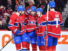 Montreal Canadiens' Mike Matheson, from left, Nick Suzuki, Rafaël Harvey-Pinard and Kirby Dach celebrate Harvey-Pinard's goal during the second period against the Edmonton Oilers at the Bell Centre in Montreal on Feb. 12, 2023.
