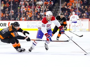 Joel Farabee (86) of the Philadelphia Flyers and Canadiens' Alex Belzile challenge for the puck at Wells Fargo Center on Friday, Feb. 24, 2023, in Philadelphia.