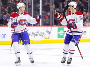Canadiens' Jesse Ylonen (56) and Justin Barron (52) celebrate a goal by Ylonen during the third period against the Philadelphia Flyers at Wells Fargo Center on Friday, Feb. 24, 2023, in Philadelphia.