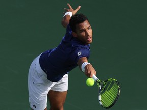 Montreal's Félix Auger-Aliassime plays a backhand against Maxime Cressy of the U.S. at the Dubai Duty Free Championships on Feb. 28, 2023.