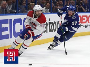 Phillip Danault of the Montreal Canadiens is defended by Yanni Gourde of the Tampa Bay Lightning during the first period in Game Five of the 2021 NHL Stanley Cup Final on July 7, 2021.