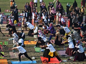 People take part in a yoga training session at a university in Lahore, Pakistan on Feb. 26, 2023.