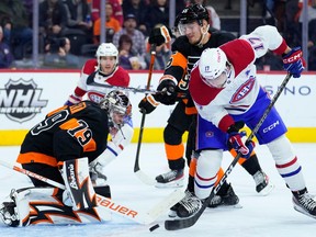 Canadiens' Josh Anderson (17) tries to deflect the puck past Philadelphia Flyers' Carter Hart (79) and Rasmus Ristolainen (55) on Friday, Feb. 24, 2023, in Philadelphia.