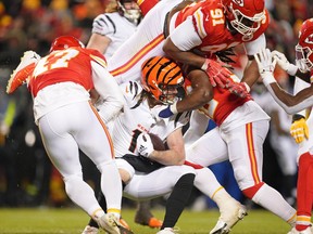 Harvard researchers point out that repeated blows to the head and injuries to knees, hips, ankles and shoulders, which are so common in football, are linked to poor brain and joint health. Above: The Cincinnati Bengals and the Kansas City Chiefs tangle in the AFC Championship game on Jan 29, 2023.