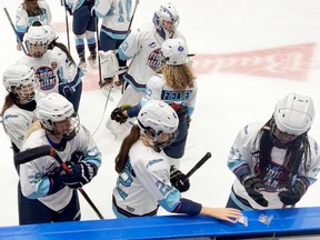 In this image taken from video, members of the Florida Alliance prepare for their hockey game against England at the International Peewee Tournament being played at the Videotron Centre in Quebec City on Sunday, Feb. 12, 2023. The team from Florida's "Space Coast" region was part of a 12-team all-girls division the tournament launched for the first time in its 63 year history.