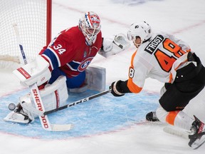 Montreal Canadiens' Jake Allen  makes a save against Philadelphia Flyers' Morgan Frost during second period in Montreal on Nov. 19, 2022.