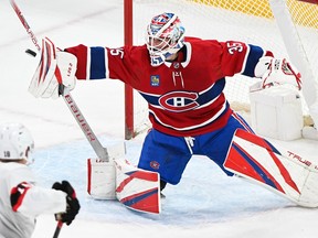 Canadiens goaltender Sam Montembeault makes a save as Ottawa Senators' Tim Stutzle (18) moves in during first period NHL hockey action in Montreal on Saturday, Feb. 25, 2023.