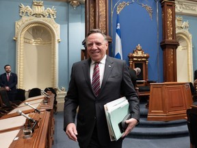 Quebec Premier Francois Legault walks in for question period at the legislature in Quebec City, Wednesday, Feb. 22, 2023.