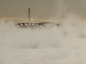 The Mercier Bridge is obscured by vapour coming off Lac St-Louis on a bitterly cold morning, Feb 3, 2023.