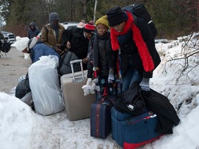 Asylum seekers from Congo cross the U.S.-Canada border at Roxham Road earlier this month, near Champlain, New York State.