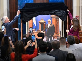 Former National Assembly Speaker François Paradis, left, and actual Speaker Nathalie Roy unveil the official picture of the former during a ceremony at the legislature in Quebec City, Wednesday, Feb. 22, 2023.