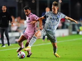 Inter Miami CF forward Corentin Jean (14) battles for the ball against CF Montréal midfielder Lassi Lappalainen (21) during the first half at DRV PNK Stadium on Saturday, Feb. 25, 2023, in Fort Lauderdale.