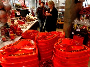 Customers shop in a store selling Valentine's Day chocolates in New York City. "Getting a heart-shaped box of chocolate is not as cheesy as I once thought," Martine St-Victor writes.