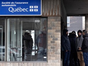 People wait almost three hours in line at the SAAQ outlet on St-Jacques St. in Montreal on Wednesday, Feb. 22, 2023.