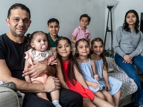 Ayman Alsabbagh at home in Brossard with his seven children: 18-month-old Cedrah; Celine, 6; Sophie, 5; Ella, 5; Sara, 14; with 13-year-old Barjas and five-year-old Justin behind.