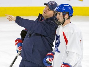 Laval Rocket head coach Jean-François Houle speaks with Xavier Simoneau during practice at the Place Bell Sports Complex in Laval on Feb. 28, 2023.