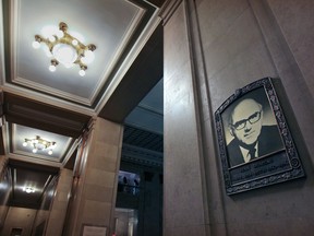 A portrait of former mayor Jean Drapeau hangs at Montreal city hall in 2012. Political parties at the municipal level are rare in the rest of Canada, writes Peter F. Trent.