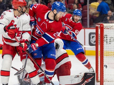 Canadiens' Mike Hoffman, rear, fires the puck past Carolina Hurricanes goalie Antti Raanta while Habs' Jonathan Drouin and Canes' Shayne Gostisbehere watch during the first period of a National Hockey League game in Montreal Tuesday March 7, 2023.