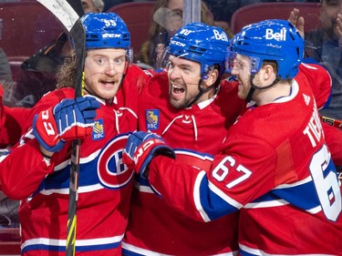 Canadiens' Alex Belzile, centre, celebrates his goal with teammates Michael Pezzetta, left, and Chris Tierney during first period of National Hockey League game against the Carolina Hurricanes in Montreal Tuesday March 7, 2023.