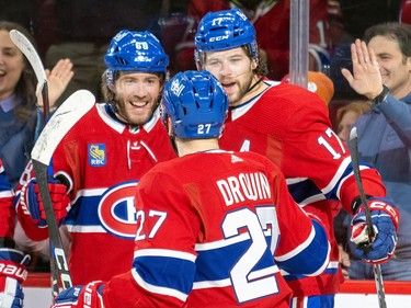 Canadiens' Mike Hoffman, left, celebrates his first period goal with team-mates Josh Anderson and Jonathan Drouin during National Hockey League game against the Carolina Hurricanes in Montreal Tuesday March 7, 2023.