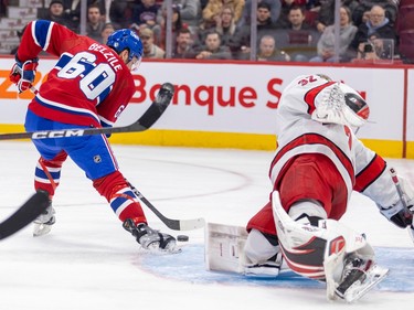 Canadiens' Alex Belzile scores on a backhand past Carolina Hurricanes Antti Raanta during first period of National Hockey League game in Montreal Tuesday March 7, 2023.