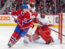 Canadiens rookie Rafaël Harvey-Pinard chases the puck behind the Hurricanes net as Brent Burns and goalie Frederik Andersen look on during a game at the Bell Centre this month.