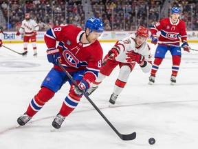 Canadiens' Mike Matheson tries to control a rolling puck under pressure from Hurricanes' Andrei Svechnikov during a game in early March at the Bell Centre.