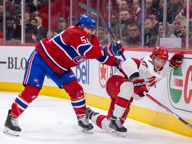 Canadiens' David Savard checks Carolina Hurricanes' Andrei Svechnikov into the end boards during the second period of a National Hockey League game in Montreal Tuesday March 7, 2023.